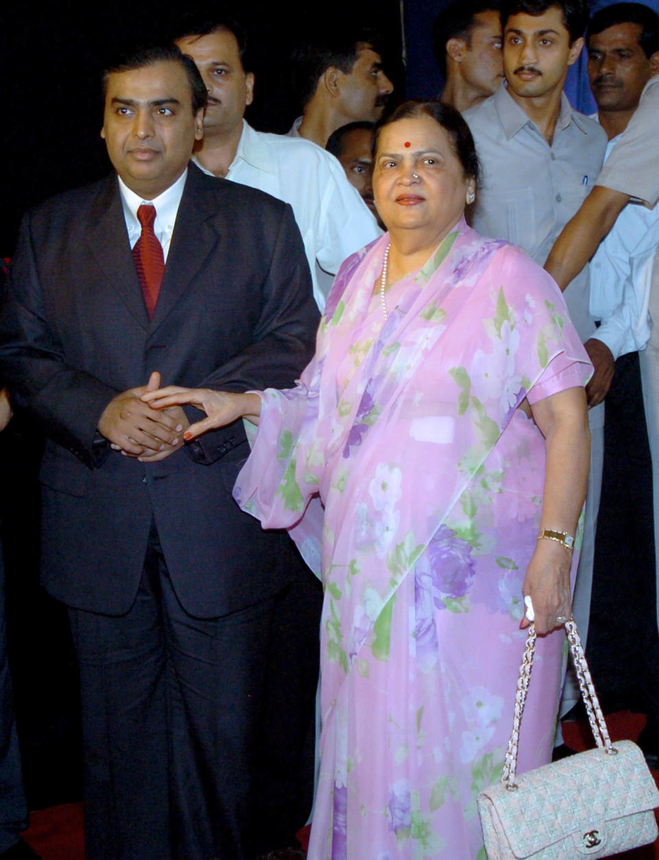 (FILES) In this picture taken August 3, 2005, Chairman of Reliance Industries Limited Mukesh Ambani (L) is accompanied by his mother Kokilaben as he arrives at the company's 31st Annual General Meeting in Mumbai. An Indian judge has told India's Ambani brothers to get their mother to settle their latest fight over natural gas supplies, telling them it is in the "national interest," a report said on August 22, 2008. The two brothers, listed by Forbes magazine as among the world's six richest men, have been at odds since 2005 over a supply agreement from the Krishna Godavari basin off India's east coast. AFP PHOTO/Indranil MUKHERJEE/FILES