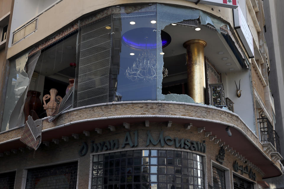 A storefront is seen with the windows broken during deadly clashes that erupted Thursday along a former 1975-90 civil war front-line between Muslim Shiite and Christian areas, in Ain el-Remaneh neighborhood, Beirut, Lebanon, Friday, Oct. 15, 2021. Schools, banks and government offices across Lebanon shut down Friday after hours of gun battles between heavily armed militias killed six people and terrorized the residents of Beirut. (AP Photo/Bilal Hussein)