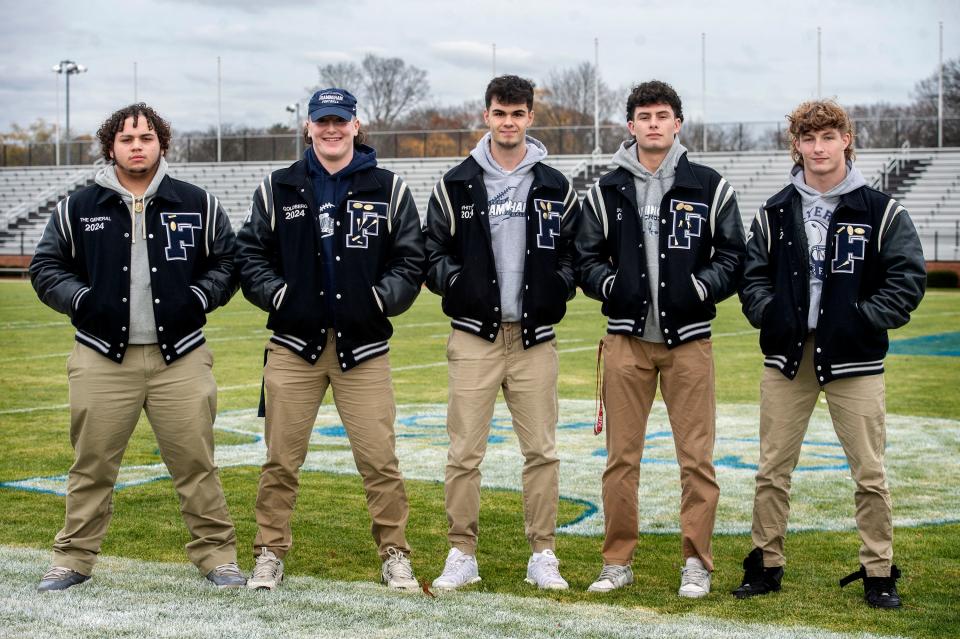Framingham High School football captains from left: Angel Colon, Henry Goldberg, Caiden Whitney, Nick Duplessis, and Ben Lincoln, at Bowditch Field, Nov. 21, 2023.