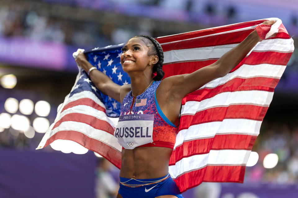 PARIS, FRANCE: AUGUST 10: Masai Russell of the United States celebrates her gold medal win in the women's 100 meter hurdles during the athletics competition at the Stade de France during the Paris 2024 Summer Olympic Games on August 10, 2024 in Paris, France. (Photo by Tim Clayton/Corbis via Getty Images)