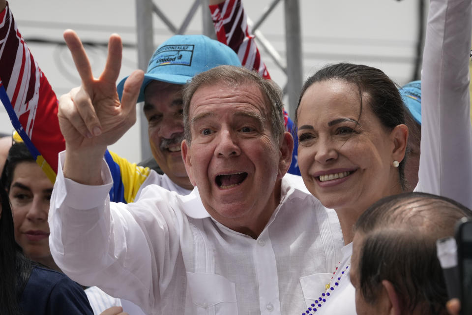 Venezuelan presidential candidate Edmundo González Urrutia flashes a V hand sign accompanied by opposition leader Mariana Corina Machado, as he kicks off his campaign for the upcoming election, in La Victoria, Venezuela, Saturday, May 18, 2024. (AP Photo/Ariana Cubillos)