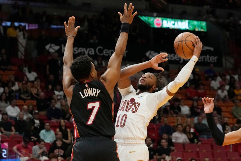 Cavaliers guard Darius Garland looks to score over Heat guard Kyle Lowry in the first half, Dec. 8, 2023, in Miami.