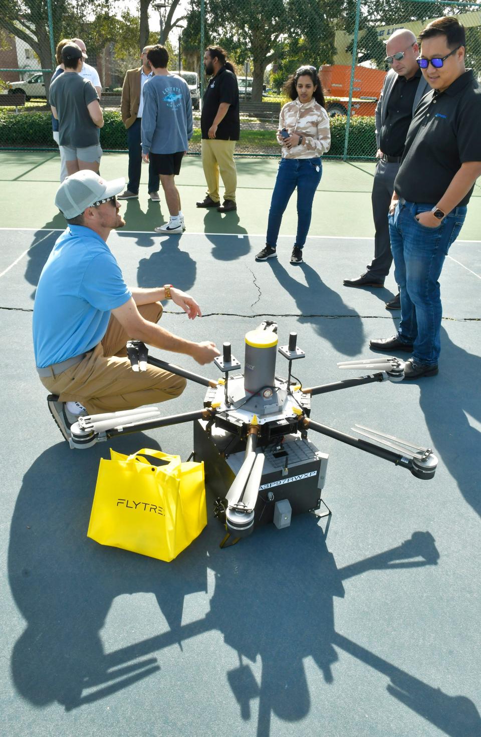 Paul Rossi, Causey Aviation Unmanned director of development and safety, discusses the Flytrex hexacopter after Thursday's drone flight during Florida Tech's Advanced Air Mobility Technology Showcase.