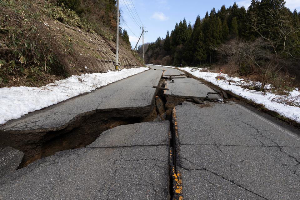 A large crack is seen in a road leading to Wajima on January 02, 2024 in Wajima, Japan. A series of major earthquakes have reportedly killed at least 55 people, injured dozens more and destroyed a large amount of homes. The earthquakes, the biggest measuring 7.1 magnitude, hit the areas around Toyama and Niigata in central Japan on Monday.