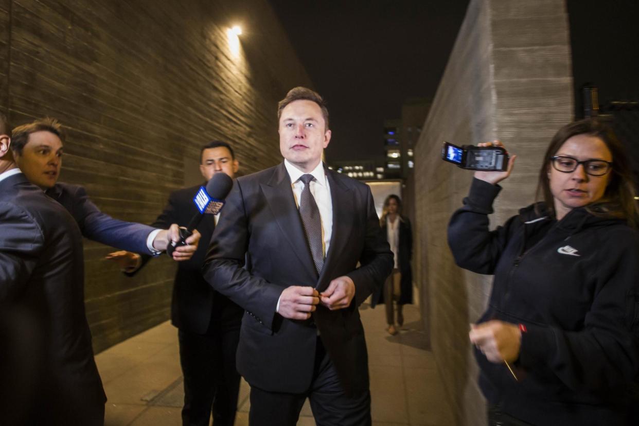 Elon Musk leaves the US District Court through a back door: Getty Images