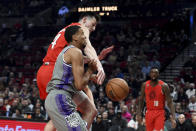 Portland Trail Blazers forward Drew Eubanks, top, blocks the shot of Sacramento Kings forward Keegan Murray, front, during the first half of an NBA basketball game in Portland, Ore., Wednesday, March 29, 2023. (AP Photo/Steve Dykes)