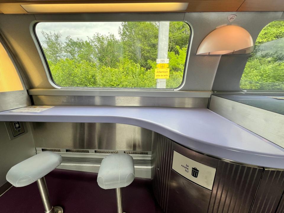 Two stools and a table in the TGV Lyria café car