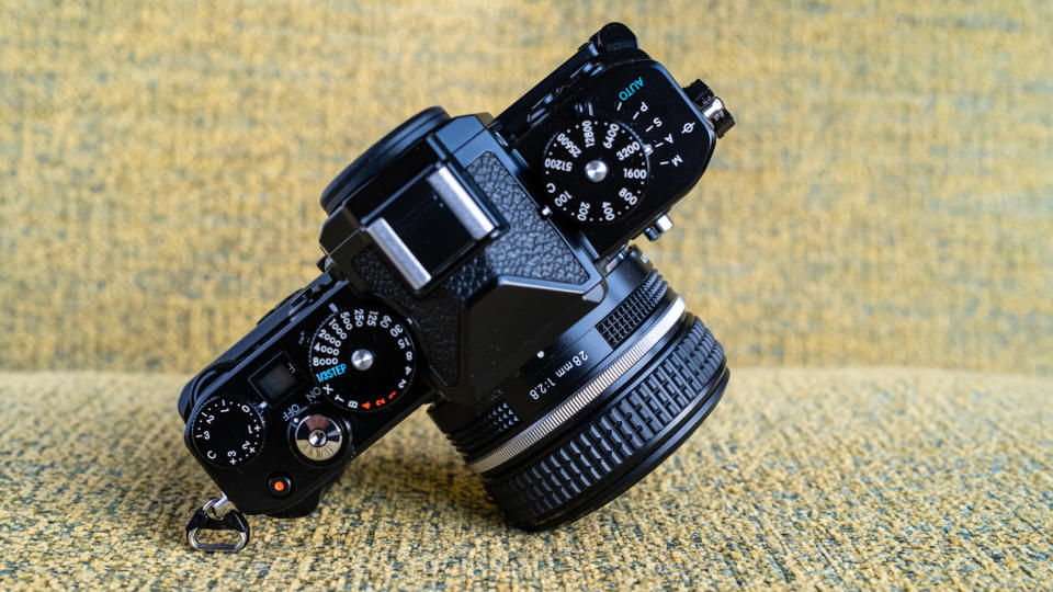 Nikon Z f camera on a vintage-style yellow chair