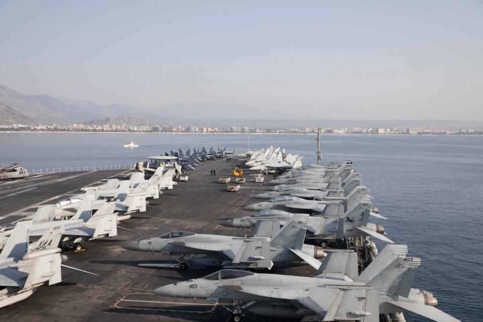 aircraft carriers are seen on the flight deck of a carrier ship with the coast of turkey in the background