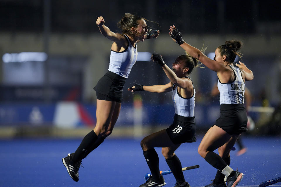 Argentina's Eugenia Trinchinetti, left, celebrates scoring against the United States, with teammates Rocio Sanchez, right, and Victoria Sauze, during the women's field hockey gold medal match, at the Pan American Games in Santiago, Chile, Saturday, Nov. 4, 2023. (AP Photo/Dolores Ochoa)