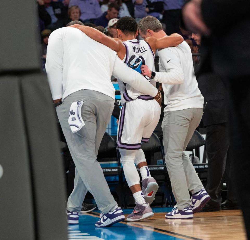 Kansas State’s Markquis Nowell is helped off the court after turning ankle while landing after a shot attempt during the second half of their east region semifinal game against Michigan State at Madison Square Garden on Thursday night. Nowell would eventually return and lead the Wildcats to an overtime win.