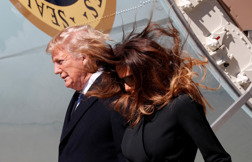 <p>Into high winds, U.S. President Donald Trump and first lady Melania Trump step from Air Force One to attend the funeral of Rev. Billy Graham in Charlotte, N.C., March 2, 2018. (Photo: Kevin Lamarque/Reuters) </p>