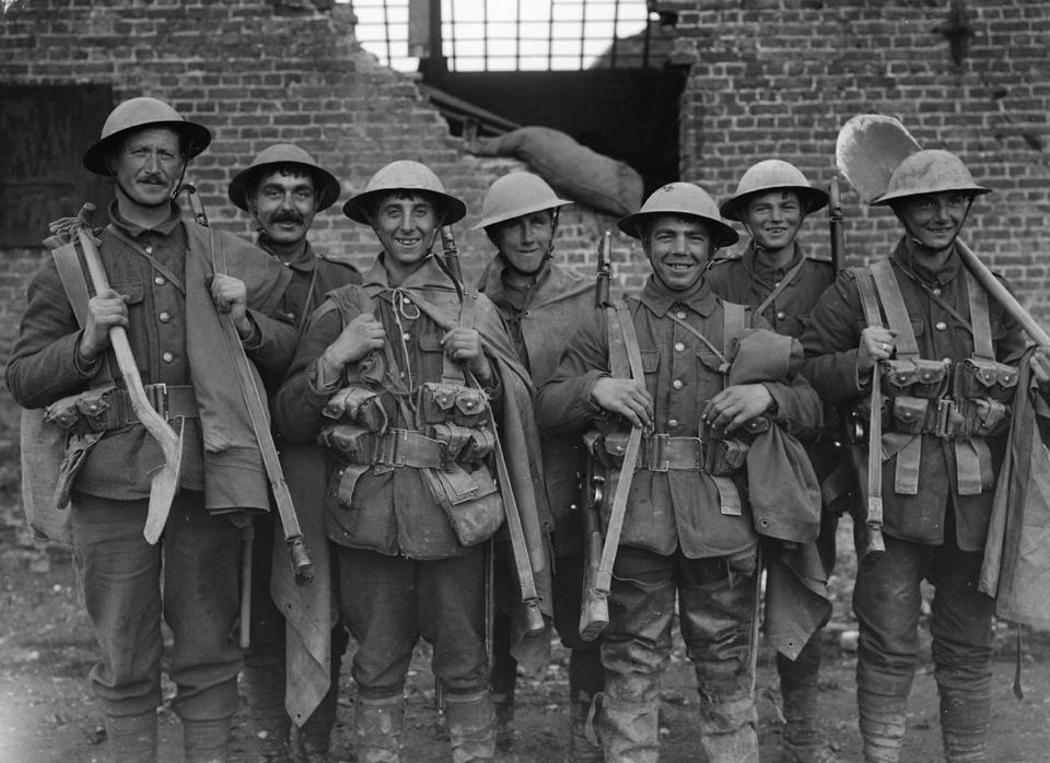 In this undated photo released by the Imperial War Museum, British soldiers with guns and shovels pose in Fleurbaix, France. Britain's Imperial War Museum is launching an ambitious online database on Monday, May 12, 2014 to remember the lives of the millions of men and women who served in World War One. The museum hopes that the history project, timed to coincide with the 100th anniversary of WWI, could form a permanent digital memorial to the scores of soldiers, nurses and others from Britain and the Commonwealth who contributed to the war by piecing together their life stories. (AP Photo/IWM Q649)