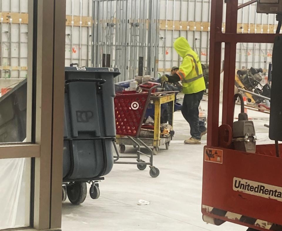 A worker prepares a former Bed Bath & Beyond in Cherry Hill for apparent use as a small-format Macy's store.