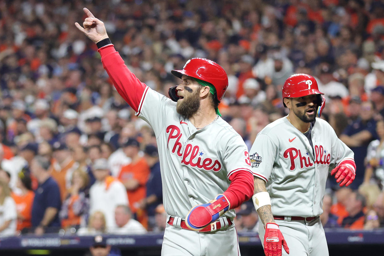 HOUSTON, TEXAS - OCTOBER 28: Bryce Harper #3 and Nick Castellanos #8 of the Philadelphia Phillies celebrate after scoring runs in the fourth inning against the Houston Astros in Game One of the 2022 World Series at Minute Maid Park on October 28, 2022 in Houston, Texas. (Photo by Carmen Mandato/Getty Images)