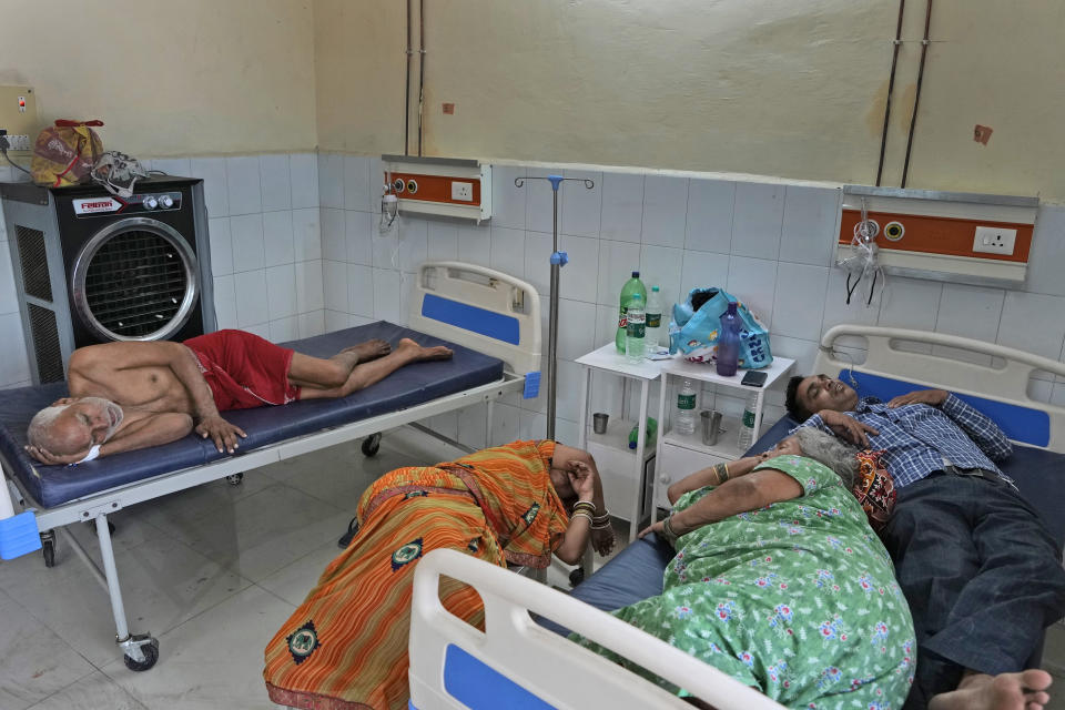 People lie at the overcrowded district hospital in Ballia, Uttar Pradesh state, India, Monday, June 19, 2023. Several people have died in two of India's most populous states in recent days amid a searing heat wave, as hospitals find themselves overwhelmed with patients. More than hundred people in the Uttar Pradesh state, and dozens in neighboring Bihar state have died due to heat-related illness. (AP Photo/Rajesh Kumar Singh)