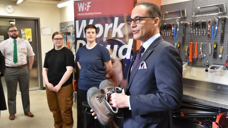 Alberta Finance Minister Joe Ceci donates work boots on pre-budget day