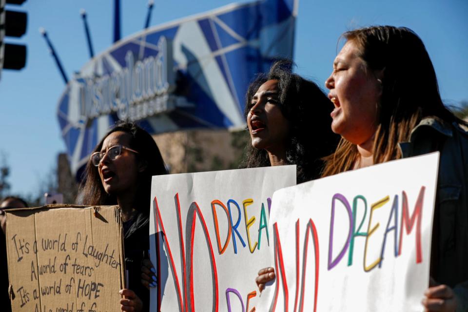 Women hold signs during a demonstration.