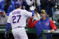 Chicago Cubs' Seiya Suzuki (27), of Japan, is congratulated by manager David Ross, right, after scoring on a one-run single by Yan Gomes during the third inning of a baseball game against the Arizona Diamondbacks in Chicago, Saturday, May 21, 2022. (AP Photo/Nam Y. Huh)