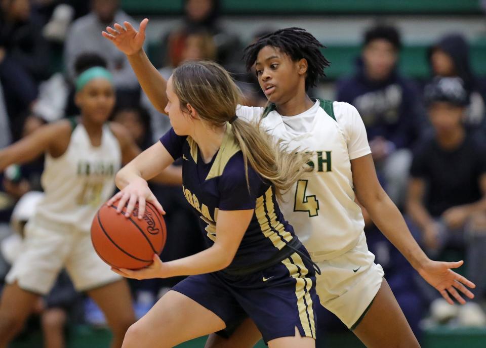 Hoban's Kennedy Arison, left, looks to pass around STVM guard Erica King during a game earlier this season.