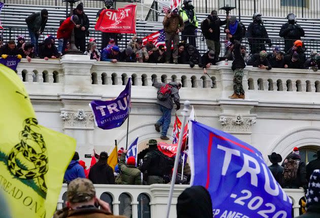 Trump supporters climb and surround the Capitol in Washington, D.C. on January 6, 2021.