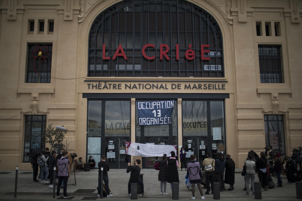 Culture workers, actors, students, and theater employees attend a general assembly at the occupied Theatre de La Criee in Marseille, southern France, Friday, March 25, 2021. Out-of-work French culture and tourism workers are occupying theaters accross France to demand more government support after a year of pandemic that has devastated their incomes and put their livelihoods on indefinite hold. (AP Photo/Daniel Cole)