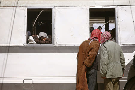 A girl looks out of a bus window during evacuation from the besieged town of Douma, Eastern Ghouta, in Damascus, Syria March 19, 2018. REUTERS/Bassam Khabieh