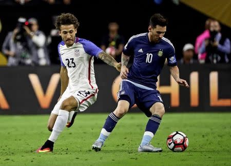 Jun 21, 2016; Houston, TX, USA; Argentina midfielder Lionel Messi (10) kicks the ball as United States defender Fabian Johnson (23) defends during the first half in the semifinals of the 2016 Copa America Centenario soccer tournament at NRG Stadium. Kevin Jairaj-USA TODAY Sports
