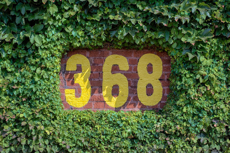 CHICAGO, ILLINOIS - SEPTEMBER 8: 368 feet sign on the outfield wall of Wrigley Field on September 8, 2014 in Chicago, Illinois
