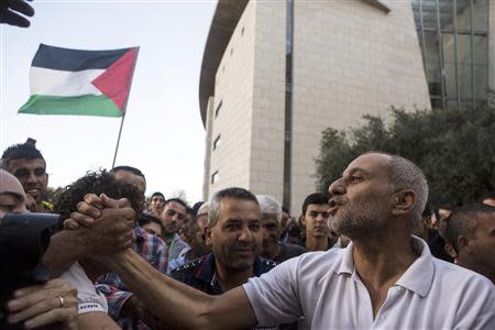 An Israeli Arab man (R) shakes hands with a supporter after his sentencing during a protest outside the district court in the northern city of Haifa November 28, 2013. REUTERS/Nir Elias