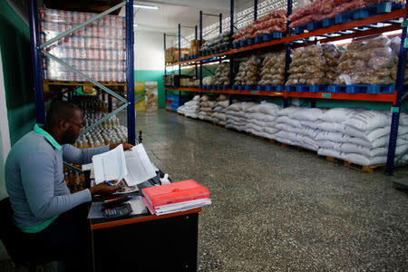 Tanelvy Borges, 33, works inside a newly opened wholesale outlet in Havana, Cuba March 22, 2018. REUTERS/Alexandre Meneghini