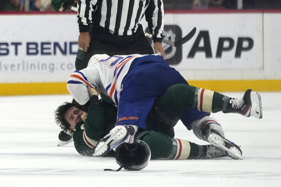 Edmonton Oilers left wing Evander Kane, top, and Minnesota Wild right wing Brandon Duhaime fight during the first period of an NHL hockey game Tuesday, Oct. 24, 2023, in St. Paul, Minn. (AP Photo/Abbie Parr)