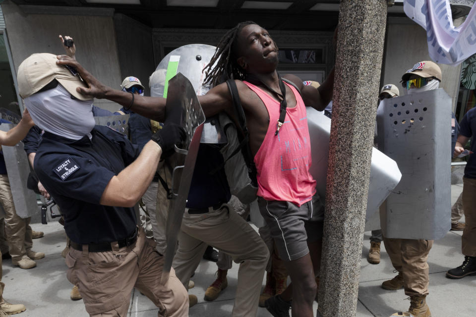 FILE - Charles Murrell, center, fends off a marcher from a group bearing insignias of the white supremacist group Patriot Front on July 2, 2022, in Boston. The Black musician who says members of the white nationalist hate group punched, kicked and beat him with metal shields during a march through Boston in 2022 sued the organization on Tuesday, Aug. 8, 2023. (AP Photo/Michael Dwyer, File)