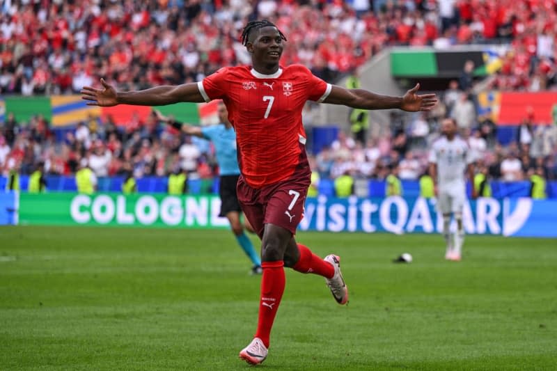 Switzerland's Breel Embolo celebrates scoring his side's third goal during the UEFA EURO 2024 Group A soccer match between Hungary and Switzerland at Cologne Stadium. Marius Becker/dpa