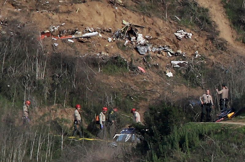 FILE PHOTO: Sheriffs and officials investigate the helicopter crash site of NBA star Kobe Bryant in Calabasas, California