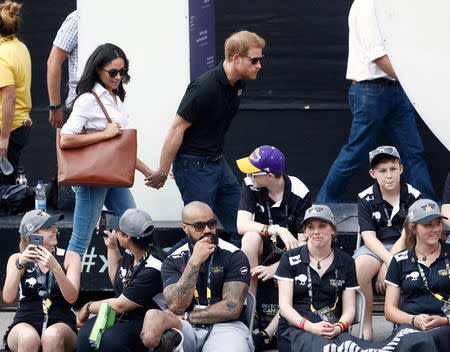 Prince Harry arrives with Meghan Markle. REUTERS/Mark Blinch