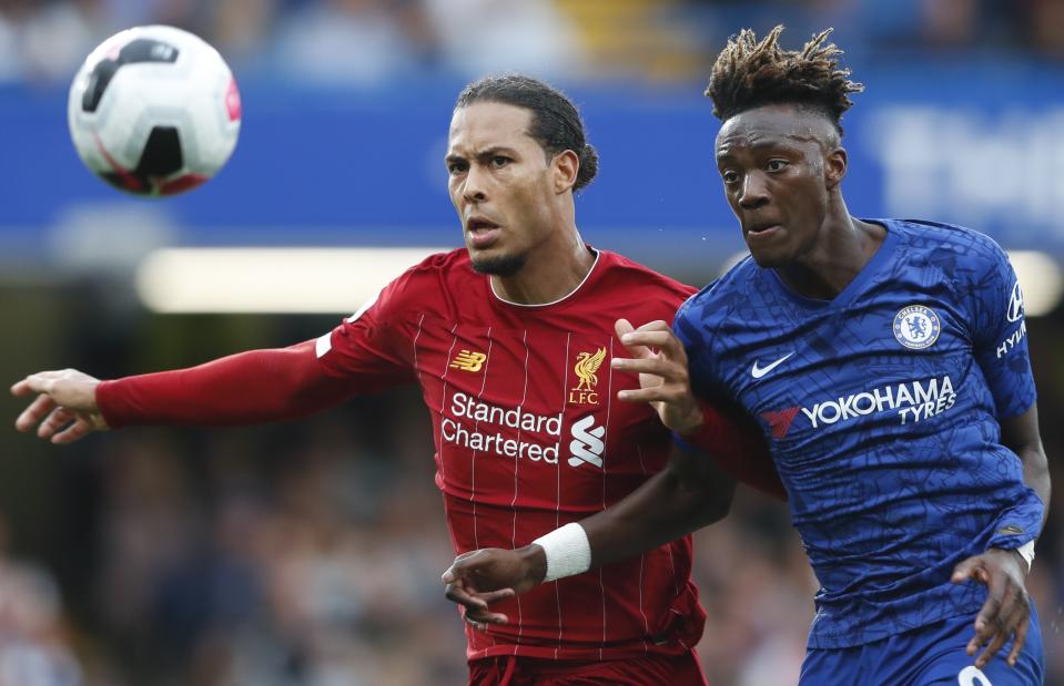 Liverpool's Virgil van Dijk, left, and Chelsea's Tammy Abraham go for the ball during the British Premier League soccer match between Chelsea and Liverpool, at the Stamford Bridge Stadium, London, Sunday, Sept. 22, 2019. (AP Photo/Frank Augstein)