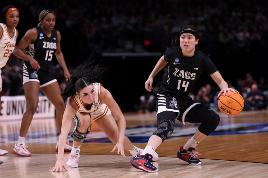 Gonzaga guard Kaylynne Truong (14) dribbles the ball as Texas guard Shaylee Gonzales defends during the first half of a Sweet 16 college basketball game in the women’s NCAA Tournament, Friday, March 29, 2024, in Portland, Ore. (AP Photo/Howard Lao)