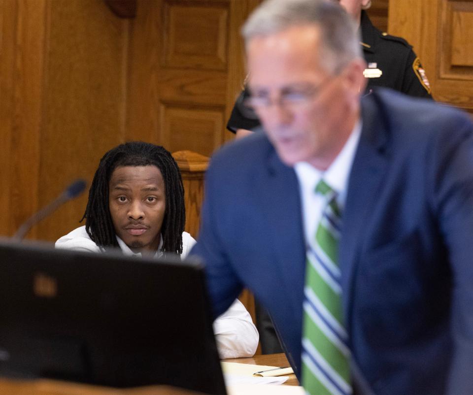 Jamaari Harper, left, listens to Dennis Barr, chief of the criminal division in the Stark County Prosecutor's Office, as Barr makes closing arguments in Harper's murder trial. The jury found Harper guilty of murder and others charges after a three-day trial before Stark County Common Pleas Judge Kristin Farmer.