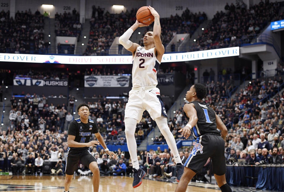 Connecticut's James Bouknight, center, shoots between Memphis' Boogie Ellis, left, and Tyler Harris, right, in the second half of an NCAA college basketball game, Sunday, Feb. 16, 2020, in Hartford, Conn. (AP Photo/Jessica Hill)