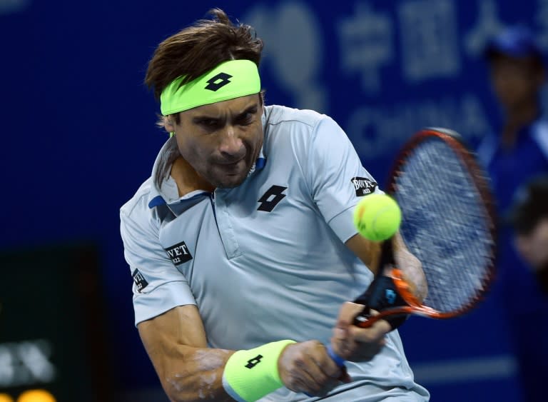 David Ferrer of Spain hits a return during the men's singles semi-final match at the China Open tennis tournament in Beijing on October 10, 2015