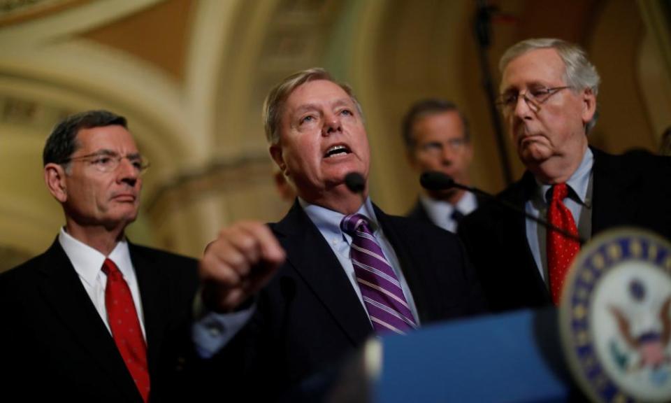 Senator Lindsey Graham, flanked by senators John Barrasso and Mitch McConnell, speaks with reporters on Capitol Hill on Tuesday.