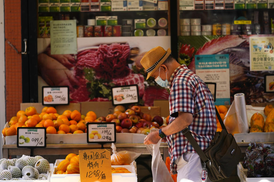 A customer shops for produce in the Chinatown neighborhood of Philadelphia, Friday, July 22, 2022. Organizers and members of Philadelphia's Chinatown say they were surprised by the 76ers' announcement that they hope to build a $1.3 billion arena just a block from the community’s gateway arch. (AP Photo/Matt Rourke)