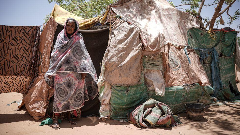 Woman standing in front of her shelter