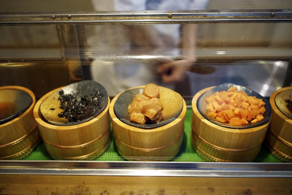 Some of onigiri ingredients are seen at the display case at Onigiri Asakusa Yadoroku, Tokyo's oldest onigiri restaurant, on June 3, 2024 in Tokyo. The word "onigiri" just became part of the Oxford English Dictionary this year. The humble sticky-rice ball, a mainstay of Japanese food, has entered the global lexicon. (AP Photo/Eugene Hoshiko)