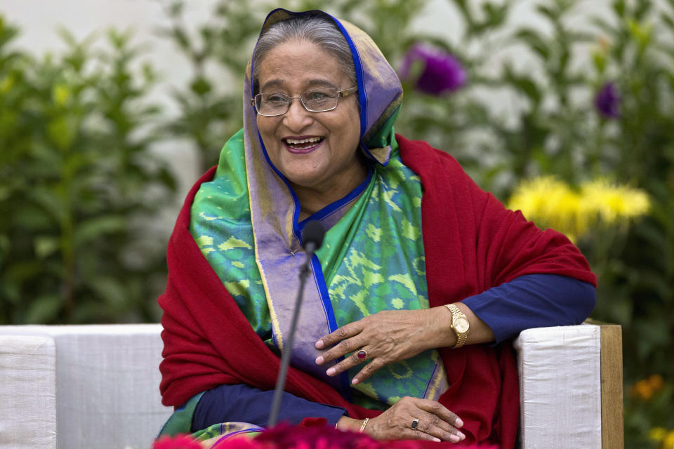 Bangladeshi Prime Minister Sheikh Hasina interacts with journalists in Dhaka, Bangladesh, Monday, Dec. 31, 2018. Bangladesh's ruling alliance won virtually every parliamentary seat in the country's general election, according to official results released Monday, giving Hasina a third straight term despite allegations of intimidation and the opposition disputing the outcome. (AP Photo/Anupam Nath)