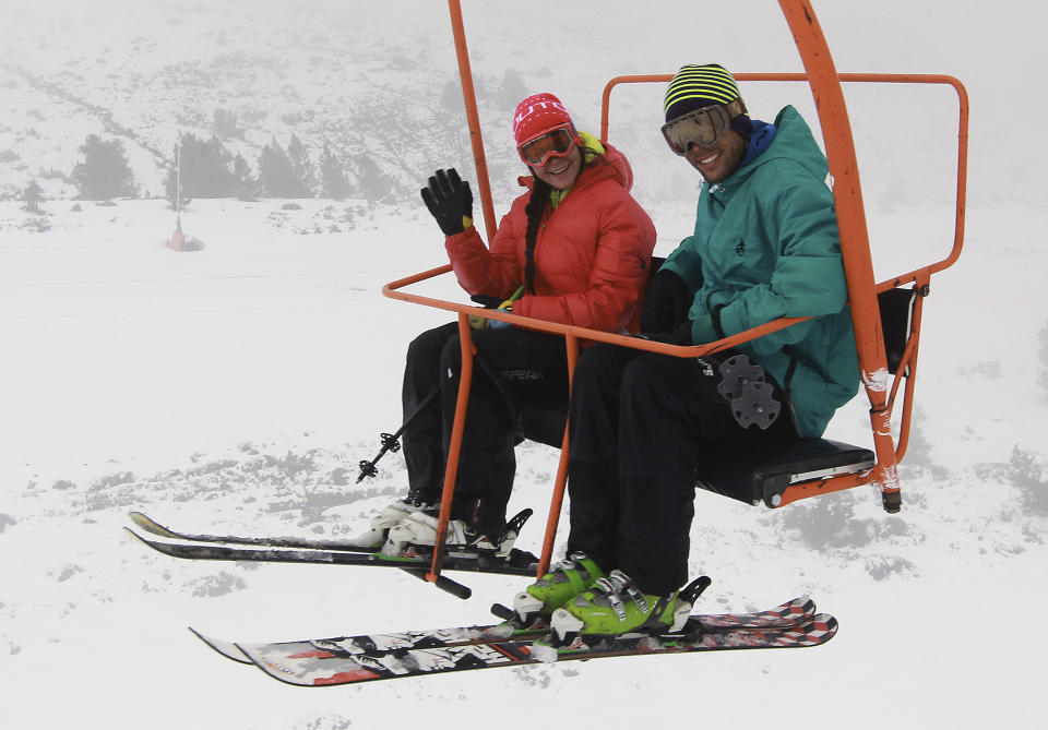 People react in the chairlift, at the ski resort Porte Puymorens, insouthwestern France, Saturday, June 1, 2013. The still-white slopes in the Pyrenees of southern France opened for business on Saturday, turning a cold damp spring into an rare June ski weekend. The Porte-Puymorens ski station opened Saturday morning at 8 a.m. for four hours in fog and light rain _ but plenty of snow with temperatures just above freezing. (AP Photo/Bob Edme)