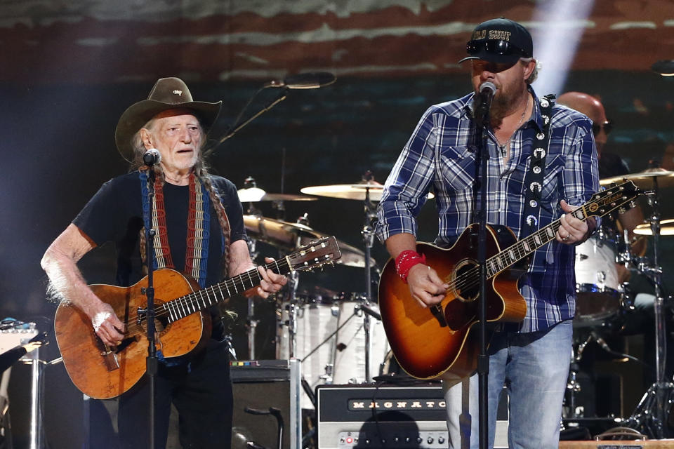 FILE - Willie Nelson, left, and Toby Keith perform at the concert "Sing me Back Home: The Music of Merle Haggard" at Bridgestone Arena on Thursday, April 6, 2017, in Nashville, Tenn. Keith, the Country music singer-songwriter has died. A statement posted on his website says Keith, who was battling stomach cancer, died peacefully Monday, Feb. 5, 2024 surrounded by his family. (Photo by Al Wagner/Invision/AP, File)