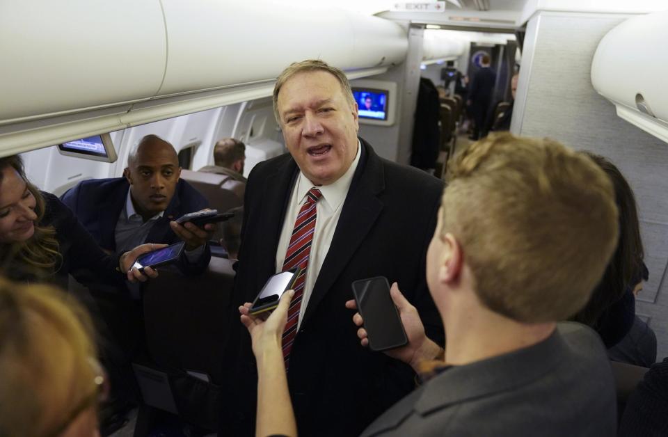 Mike Pompeo speaks to reporters aboard his plane en route to London (AP)