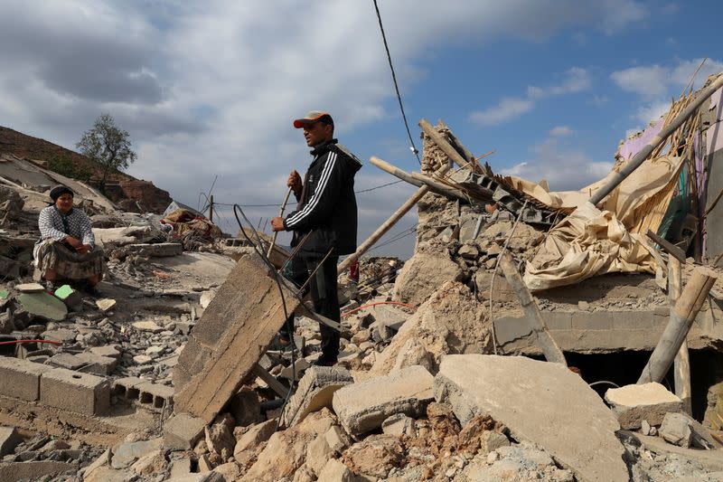 Mohamed Belkas stands on the ruins of his home where he was pulled from the rubble hours after the deadly earthquake, in Adouz